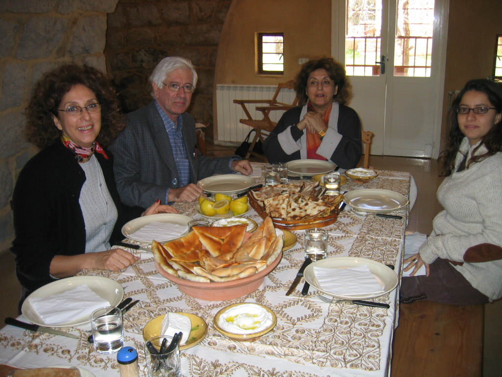 a group of four people getting ready to eat