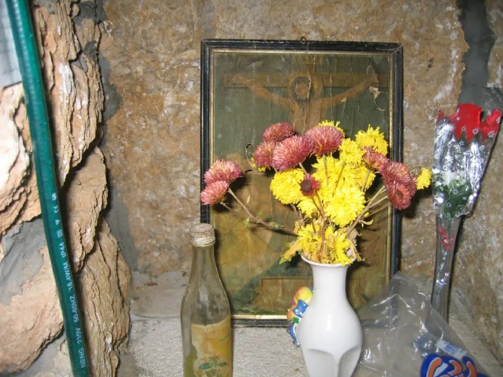Flowers left in front of a religious image