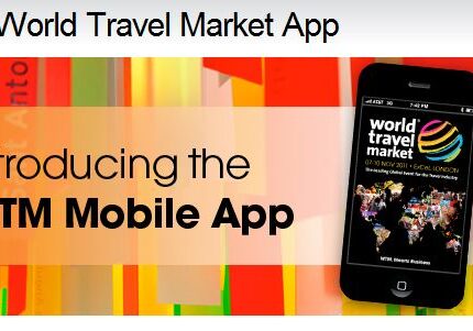 A cell phone is on the ground with text that says " world travel market app."